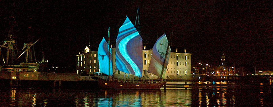 Coloured lights on sails at Amsterdam Light Festival 2013 near Amsterdam Maritime Museum